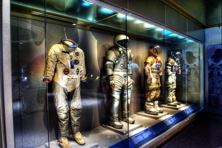 Photograph of NASA space suits on display