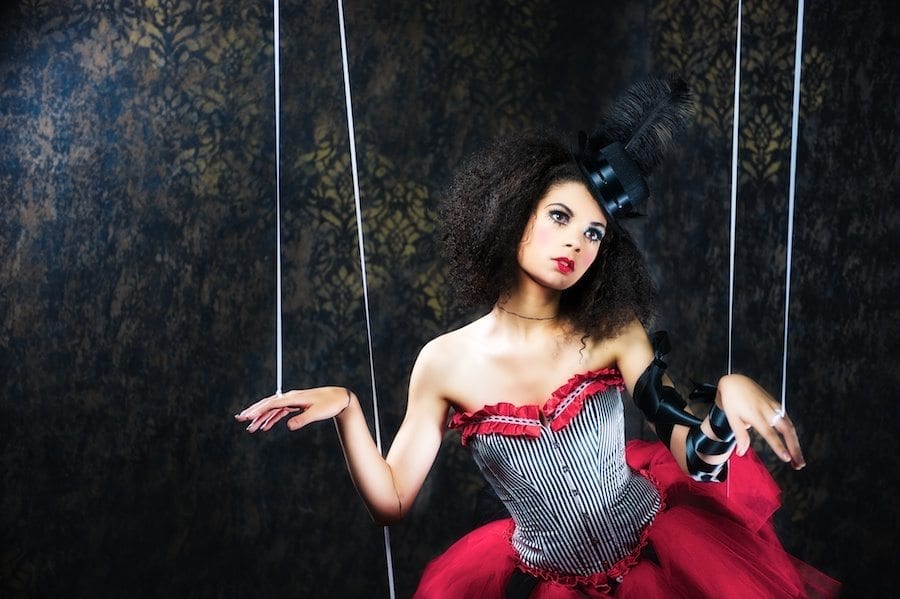 Marionette female model posing as marionette