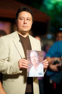 Larry Becker holding photo of Ken Toney